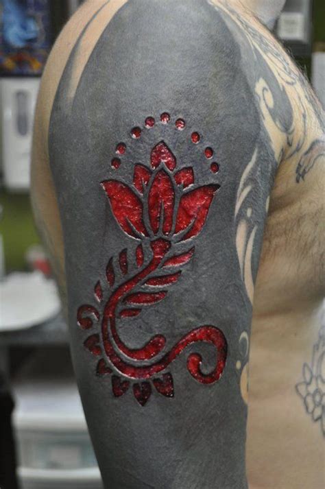 scarification over black tattoo